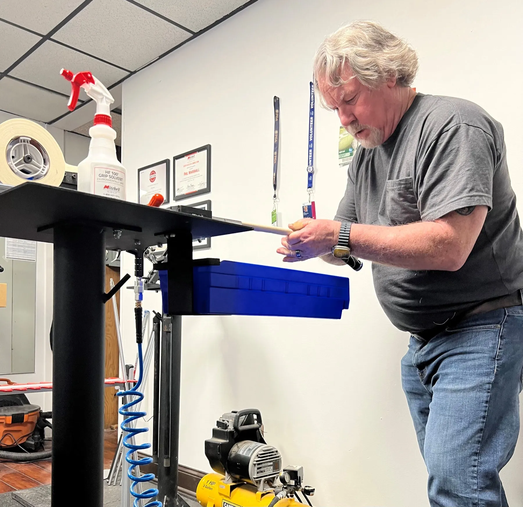 Phil regripping a club at the grip station