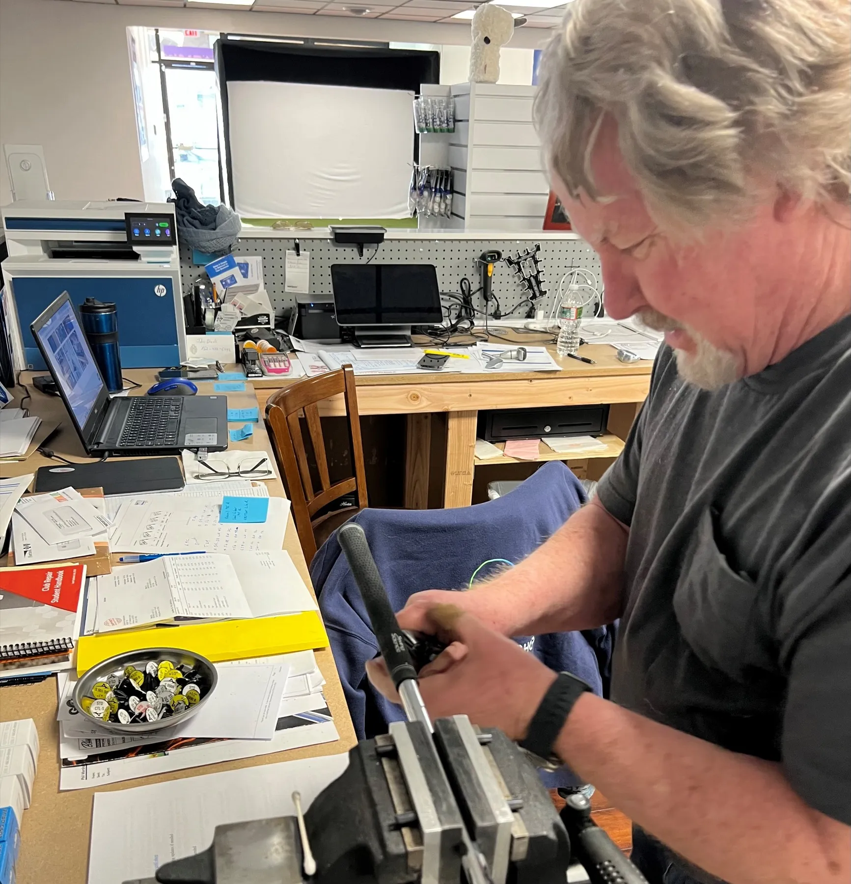 Phil working on a club held in a bench vise