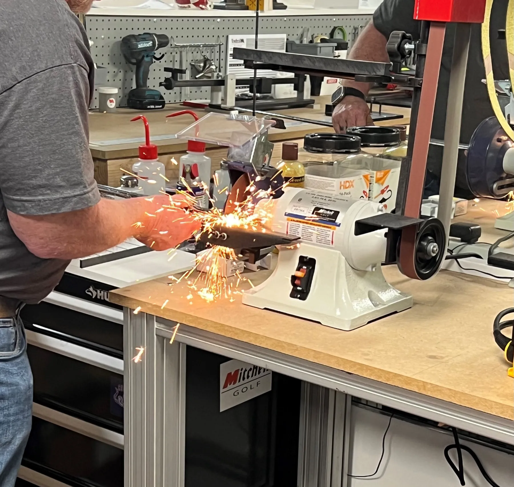 Sparks from the grinder on the repair bench